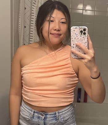 reviewer wearing the top in peach