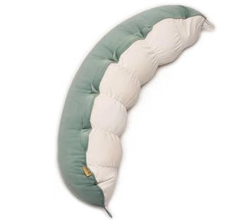 Curved body pillow with alternating plush sections, designed for comfort and support, suitable for relaxation or sleep
