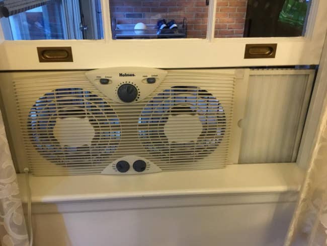a reviewer's photo of the fan in a window