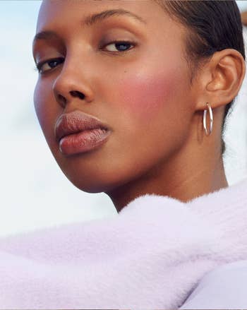 model wearing the glossier cloud paint in a 'eve' color