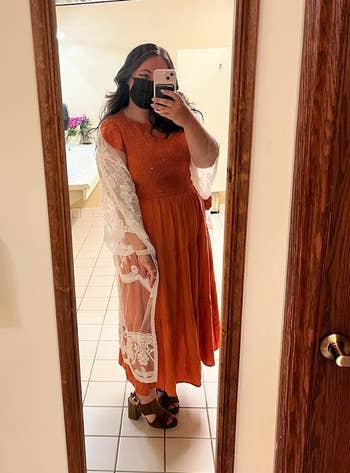 reviewer mirror selfie wearing the dress in orange