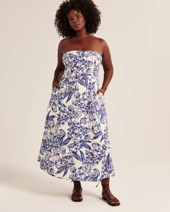 model wearing a strapless blue and white patterned linen dress