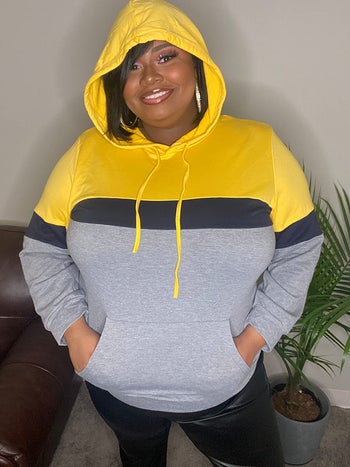 reviewer wearing the yellow color block hoodie