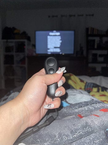 Reviewer holding their Kindle/iPad remote