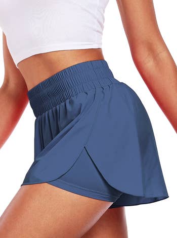 Person wearing high-waisted diversion  shorts with a flowy plan  and a fitted waistband, paired with a fitted top