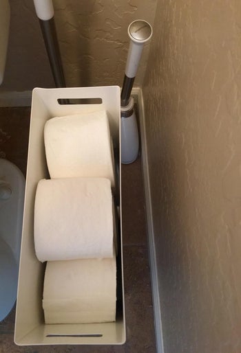 reviewer top-down photo of toilet paper rolls in the dispenser