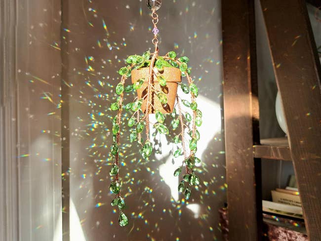 Hanging crystal works  decoration with greenish  gem leaves, casting dazzling airy  reflections