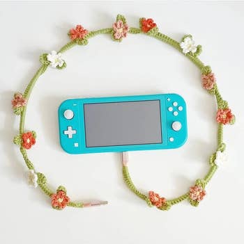 red crochet flower vine charging cable attached to a Nintendo Switch 