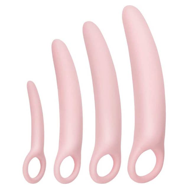 Four pink vaginal dilators side by side for size comparison