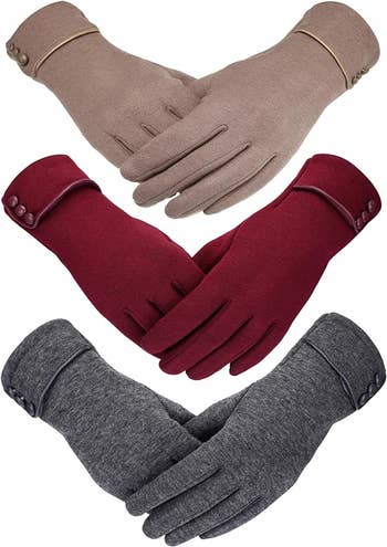 Three pairs of gloves in beige, red, and gray
