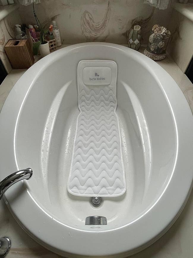 full body bath pillow in a reviewer's tub