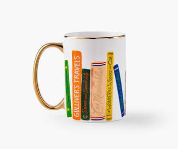 a white mug with illustrated novels on it