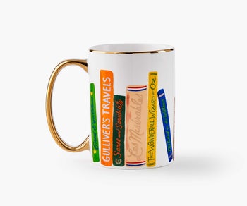 a white mug with illustrated novels on it