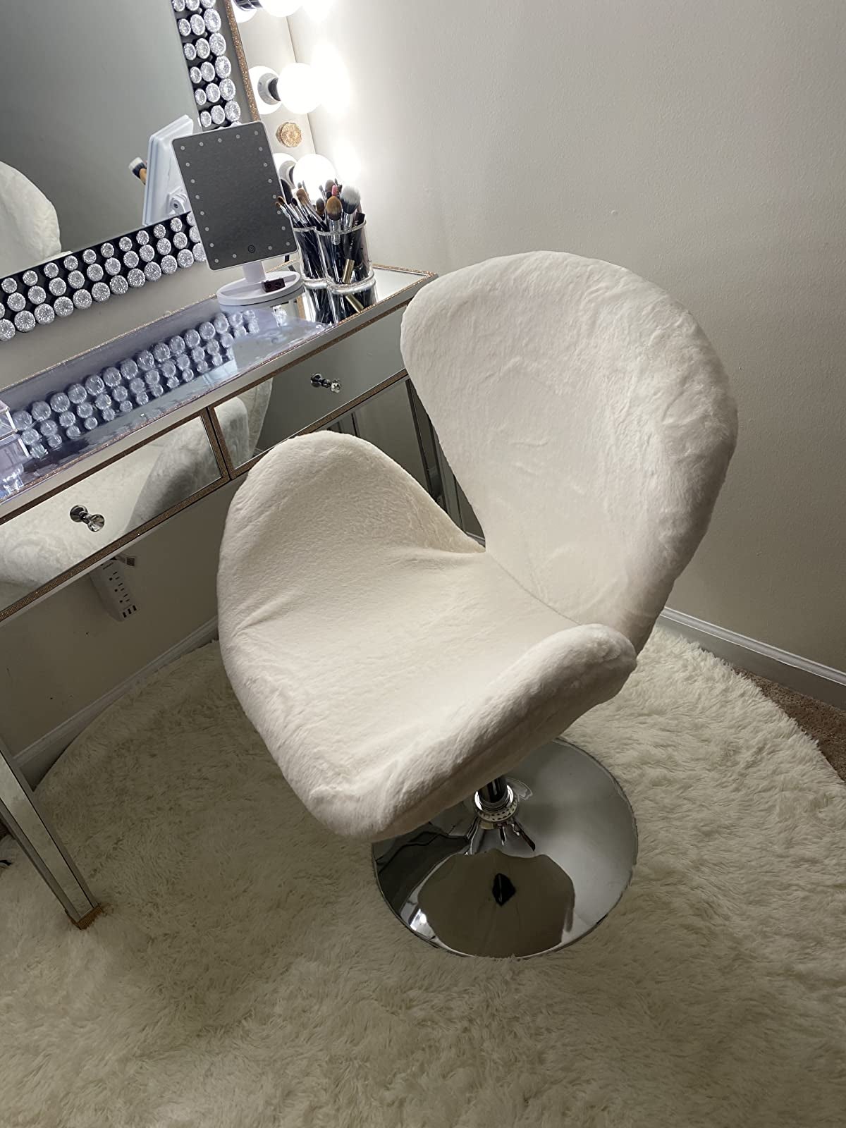 Reviewer image of white fuzzy chair with silver stand in front of white desk