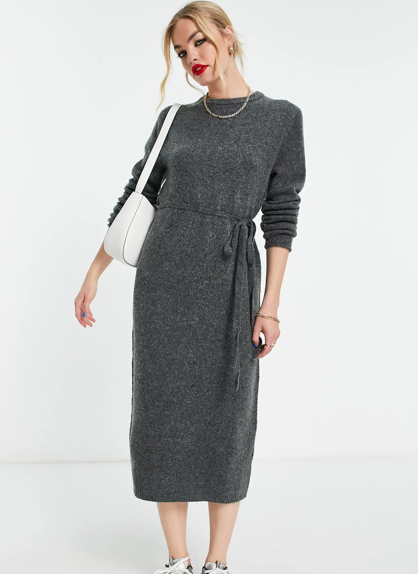Model is wearing a grey midi sweater dress