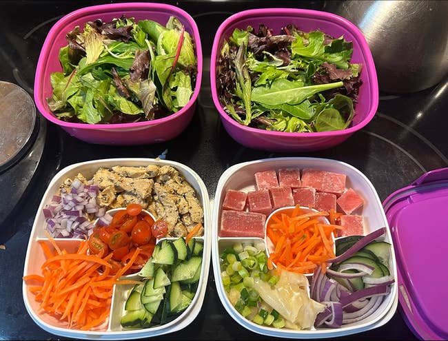 Two salad containers with greens, and two bento boxes with diced tuna, carrots, cucumber, tomato, onions, ginger, and tofu