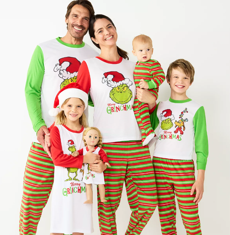 a family in matching grinch-themed pajamas