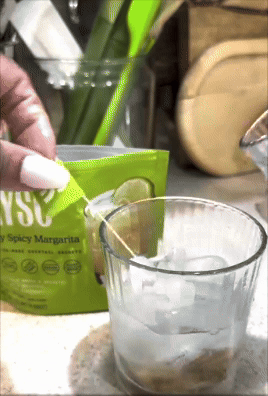 Mixing a cocktail with crystal  utilizing a packet labeled 
