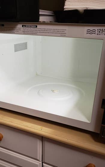 the same reviewer's microwave now looking clean after using the wipes