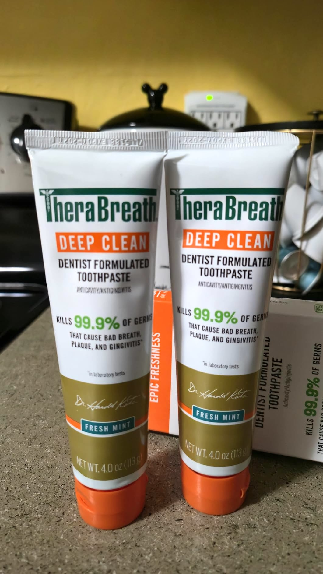 Two tubes of TheraBreath Deep Clean toothpaste, labeled as dentist-formulated to kill 99.9% of germs, with a Fresh Mint flavor