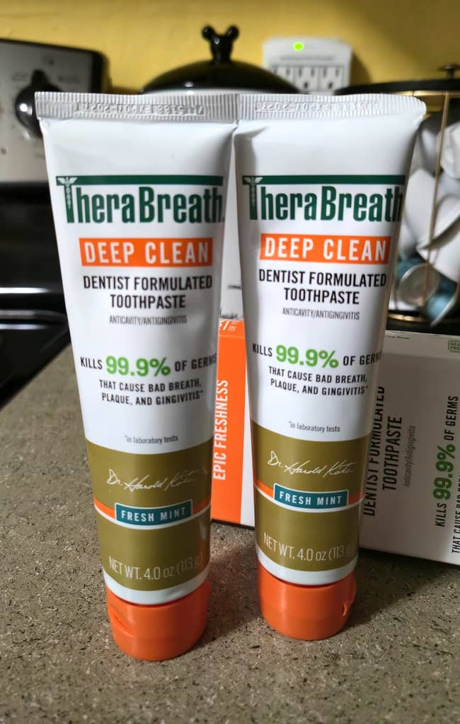 Two tubes of TheraBreath Deep Clean toothpaste, labeled as dentist-formulated to kill 99.9% of germs, with a Fresh Mint flavor
