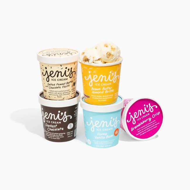 Stack of Jeni's ice cream pints featuring flavors like Salted Peanut Butter, Brown Butter Almond Brittle, Honey Vanilla Bean, and Brambleberry Crisp