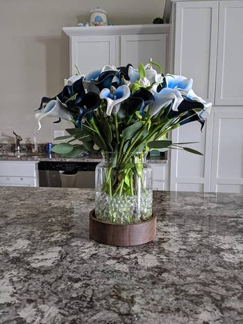 Reviewer image of product with light off and bouquet inside it on top of counter