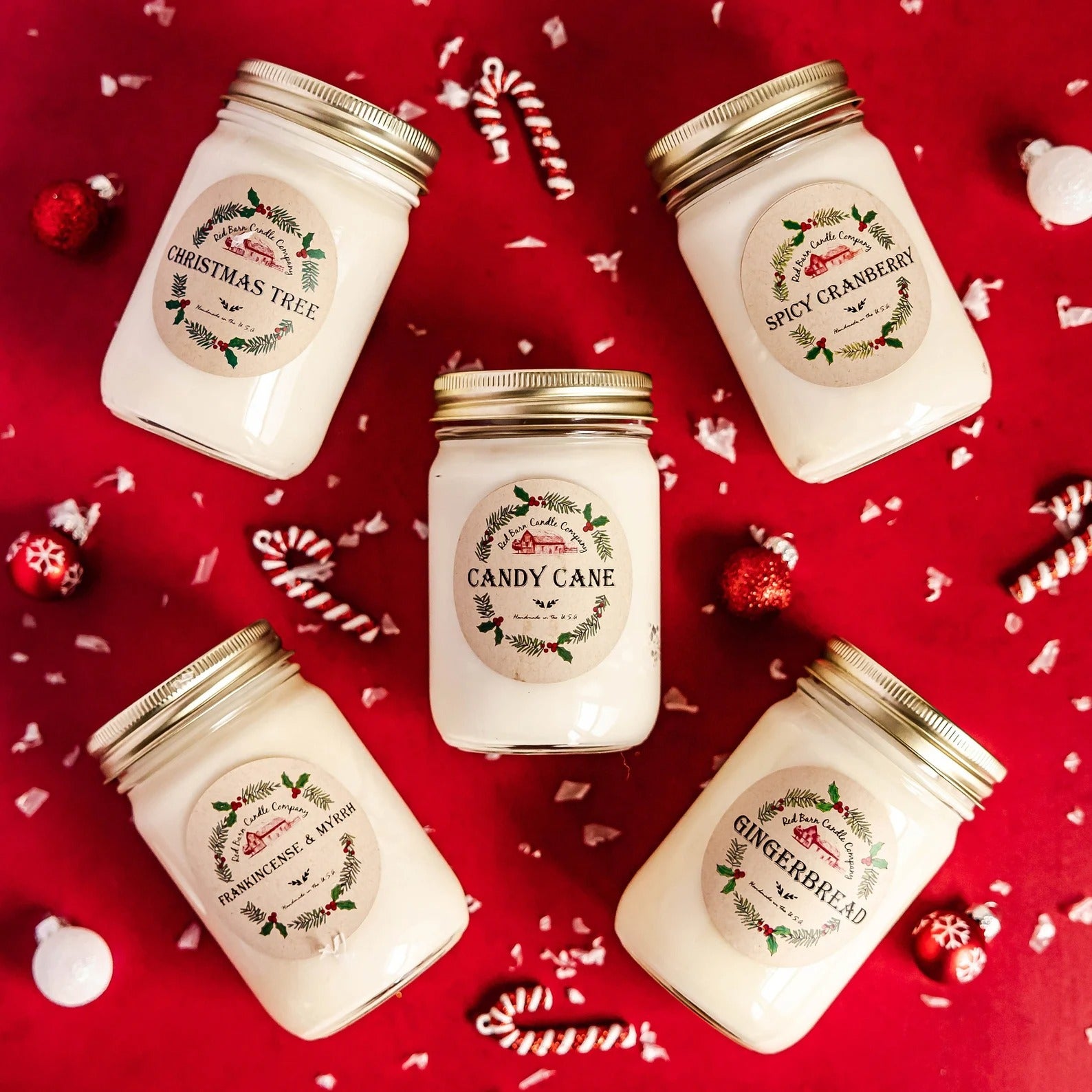 five different candles arranged around a winter holiday background