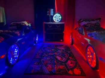 Reviewer's kids' room with two car beds one lit up blue and one red