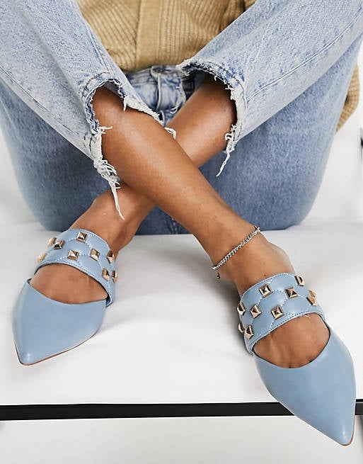 model in light blue flats with studded quilted strap