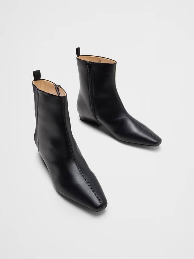 Sleek ankle boots with a pointed toed  and interior  zipper, displayed broadside  by side, perfect  for stylish and versatile footwear options