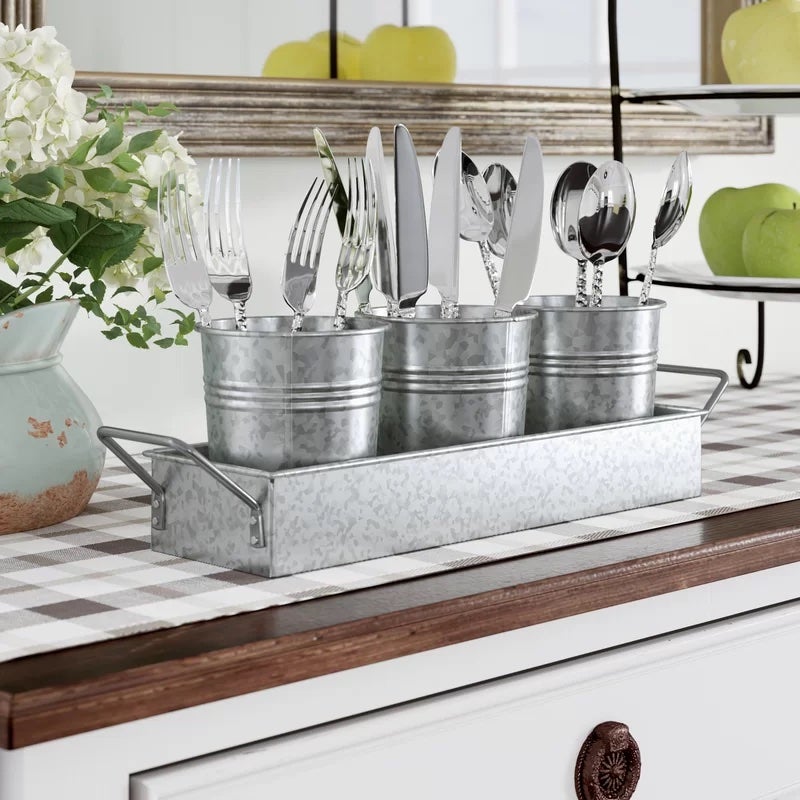 A four-piece silverware storing unit in silver