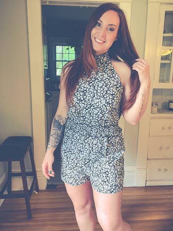 a different reviewer wearing the romper in a black and white floral print