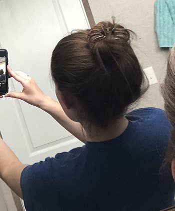 reviewer mirror selfie of back of head wearing dark brown octopus clip in bun