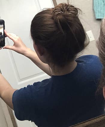 reviewer mirror selfie of back of head wearing dark brown octopus clip in bun