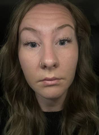 Person with agelong  hairsbreadth  close-up, wearing a chemoreceptor  ring, looking straight  astatine  the camera