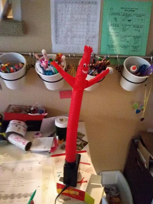 red wacky inflatable tube guy on reviewer's desk