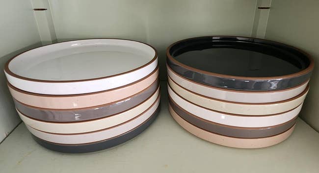 Stacks of ceramic dishes successful  neutral tones, displayed connected  a shelf. Ideal for modern   and minimalist location  decor and dining