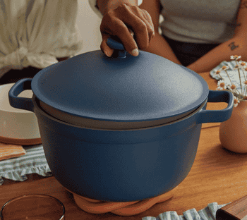 gif of someone lifting the lid off of the blue perfect pot to reveal a hot soup