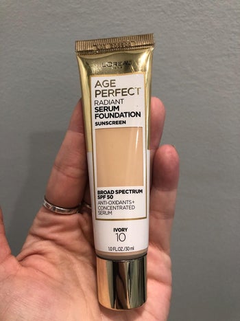 Reviewer holding L'oreal Age Perfect Radiant Serum Foundation