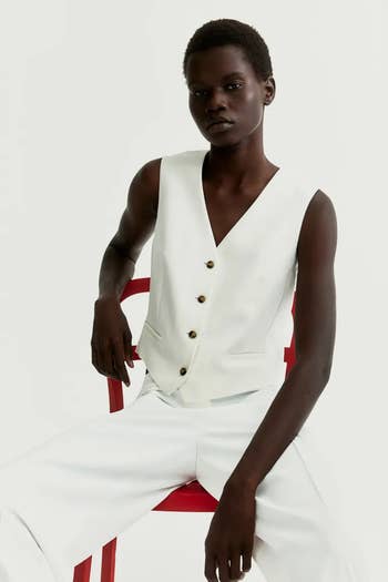 Model in white vest and trousers 