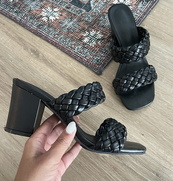 close up of reviewer holding the black sandal