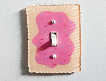 Light power   screen  designed to look   similar  a frosted donut with sprinkles, enhancing location  decor with a playful, whimsical touch
