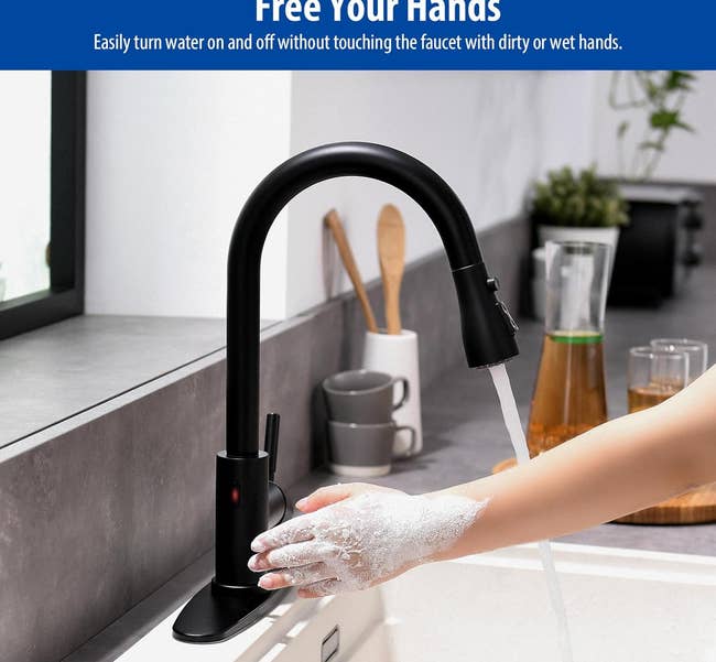 Touchless kitchen faucet demonstrating hands-free operation with soapy hands. Suitable for hygienic kitchen practices