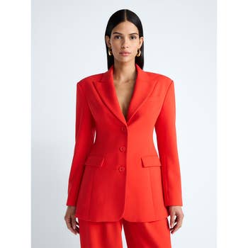 Person wearing a tailored suit with wide lapels