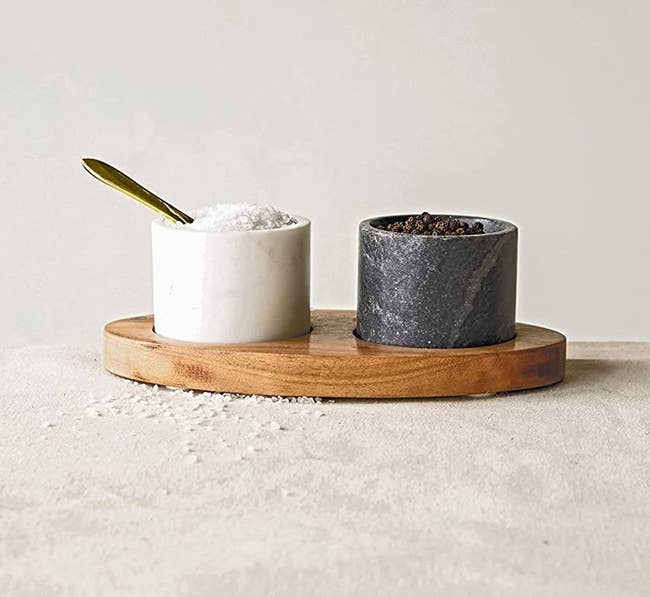 one achromatic and 1 achromatic tiny cupful successful a wood tray with a spoon successful the achromatic one