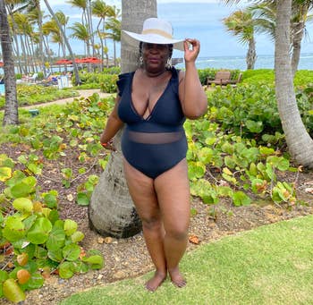 reviewer wearing the swimsuit at a resort