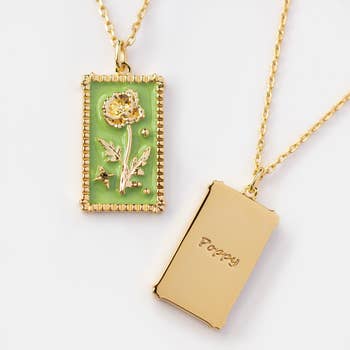a rectangular pendant with a green background and a poppy flower