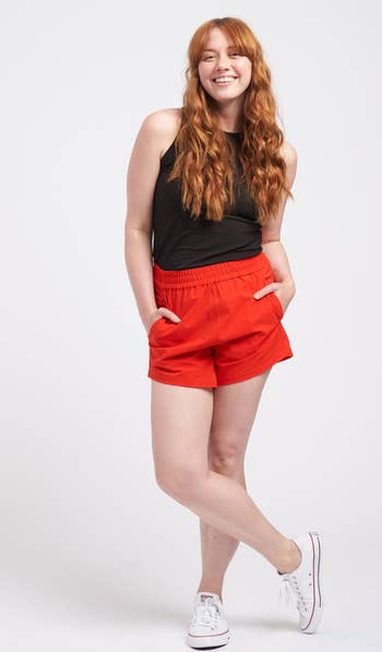 a model wearing the shorts in red 