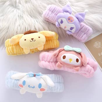 Cute plush headbands featuring popular Sanrio characters: Pompompurin, My Melody, Kuromi, and Cinnamoroll